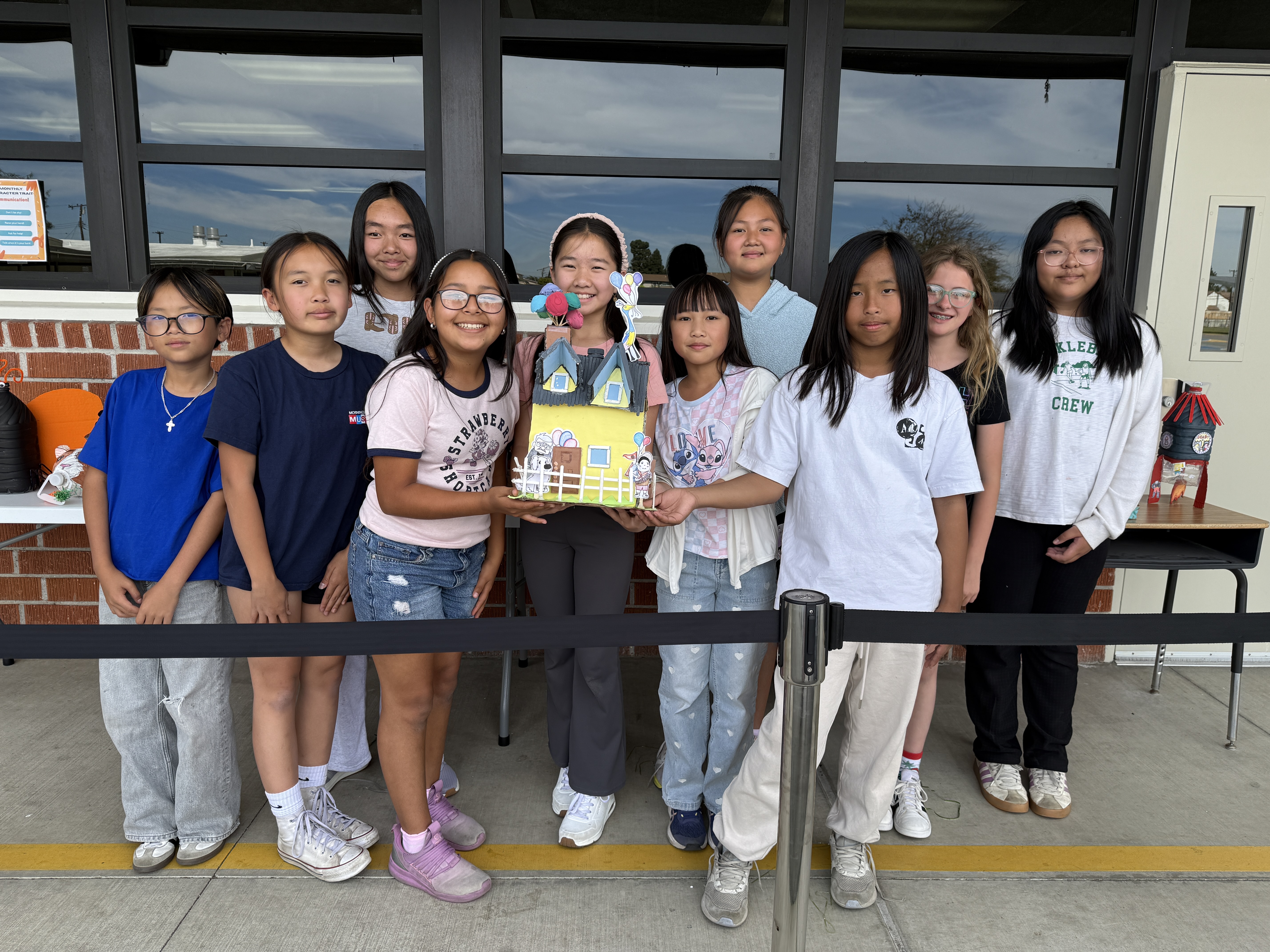 Room 42 scholars proudly pose with their winning coin jar
